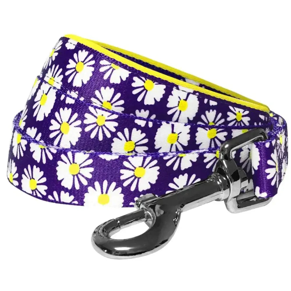 daisy print dog leash featuring a vibrant purple design with white daisies and a yellow inner lining.